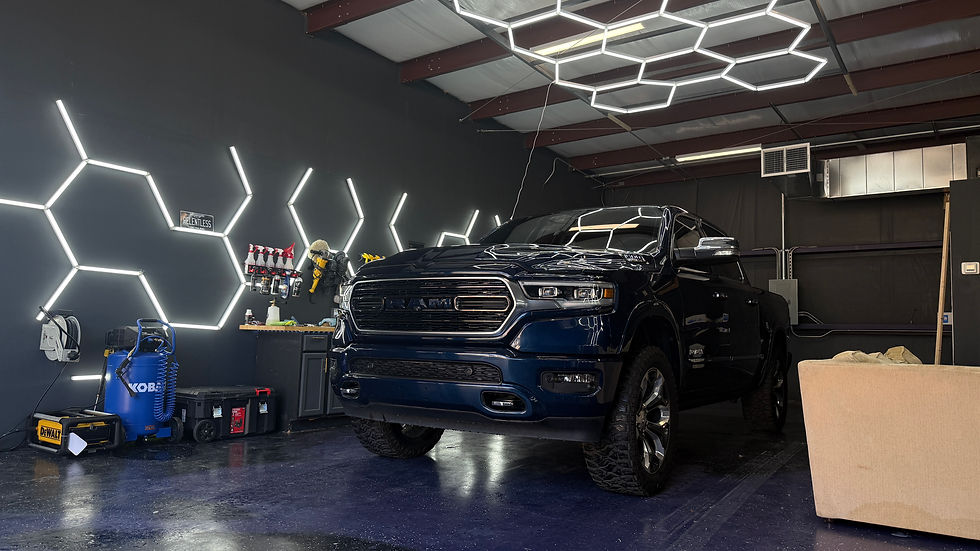 A freshly detailed black truck inside the Relentless Detailing studio